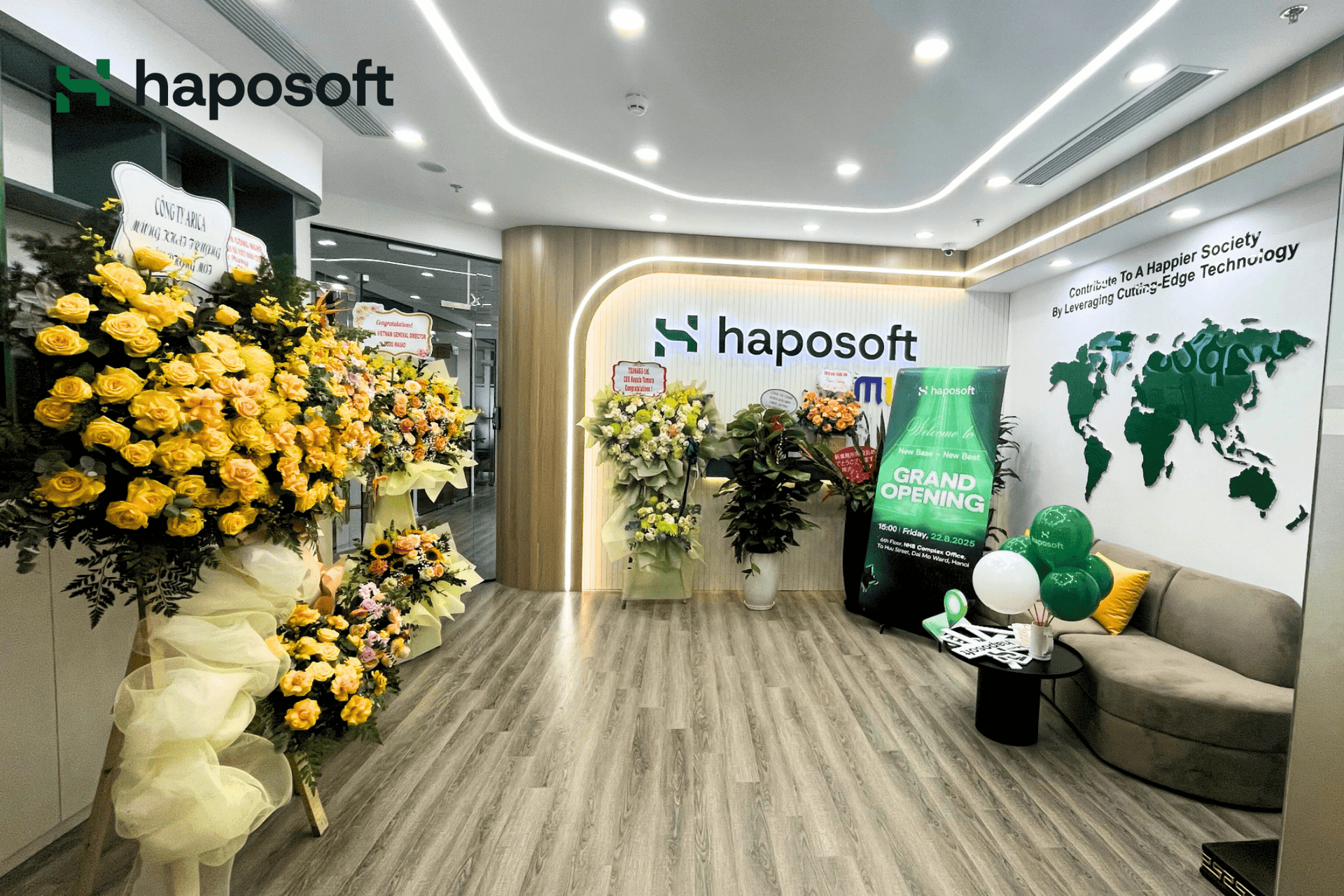 Haposoft celebrated the grand opening of its new Hanoi office with flowers and a modern workspace design.